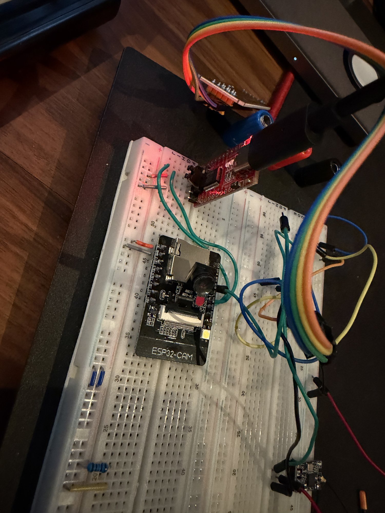 The first ESP32-CAM in a breadboard with a USB serial adapter and jumper wires